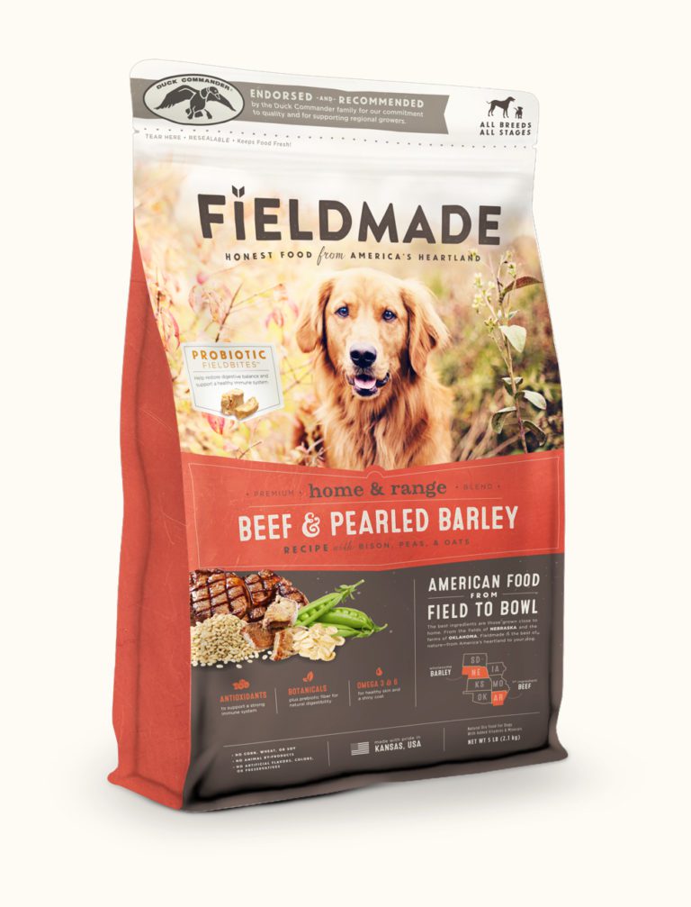 Orange and white bag of dog food showing packaging design for a pet food brand.