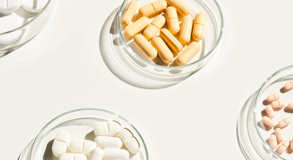 supplement capsules and pills in bowls