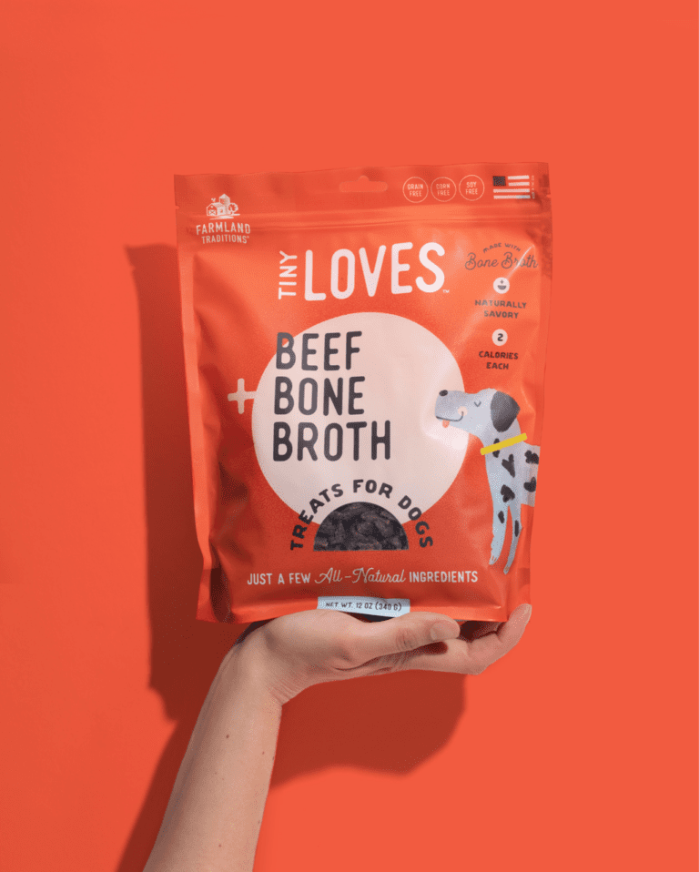 Orange bag of Tiny Loves pet brand packaging for Beef + Bone Broth treats for dogs. Pet treat branding for air-dried jerky treats from Farmland Traditions.
